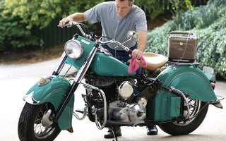 Man working on his bike with a portable oxygen concentrator