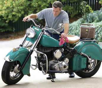 Man working on his bike with a portable oxygen concentrator