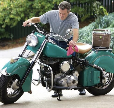Man working on his bike with a portable oxygen concentrator